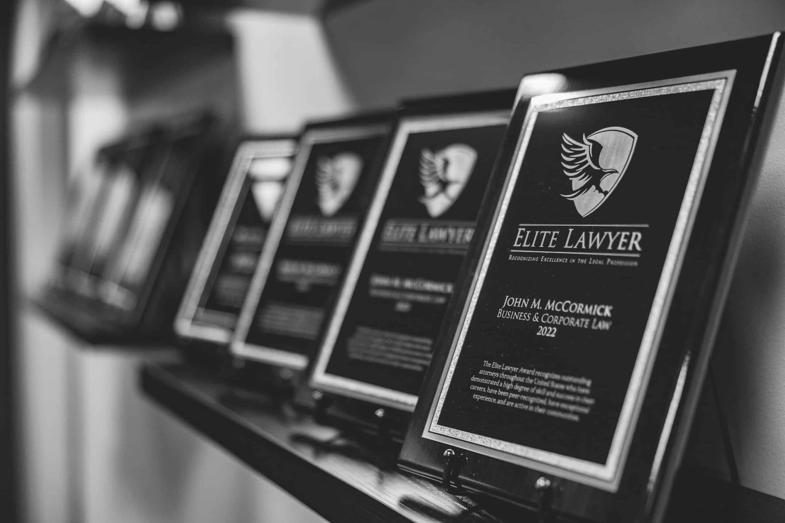 Elite Lawyer award plaques recognizing John M. McCormick for Business and Corporate Law