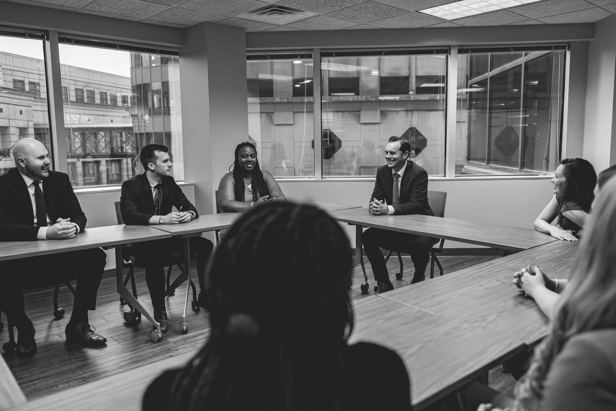 Med Contract Law attorneys discussing mistakes selling a medical practice with clients in the firm's office
