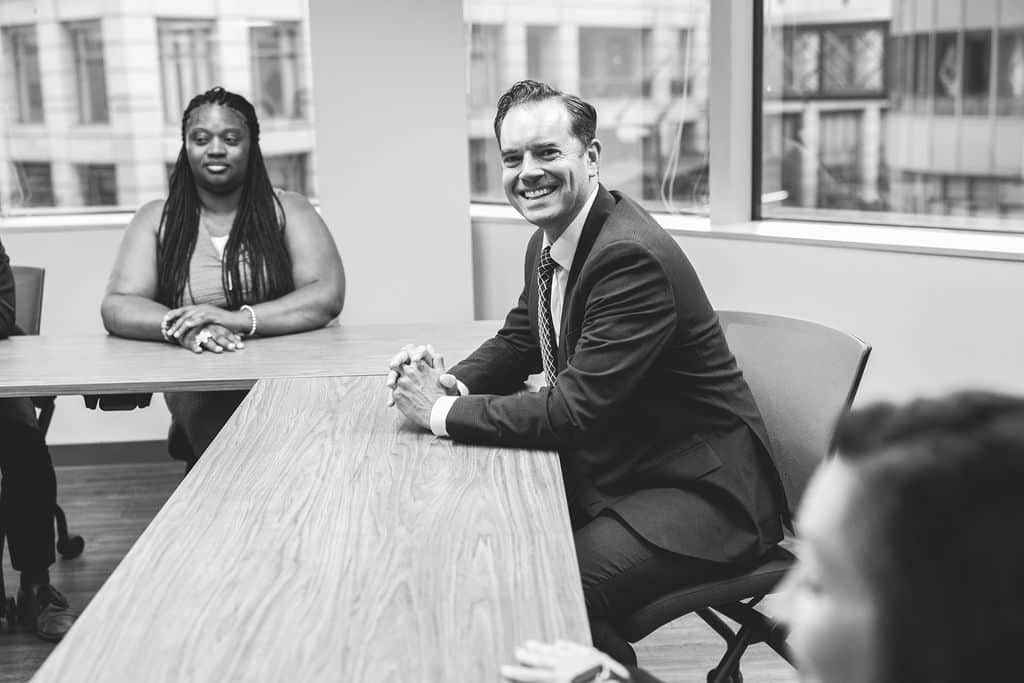 Attorney meeting with clients in a conference room at McCormick Law & Consulting