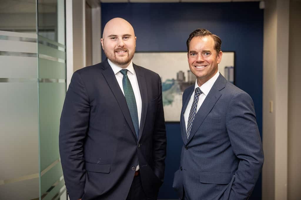 Two Med Contract Law attorneys standing in the McCormick Law & Consulting office